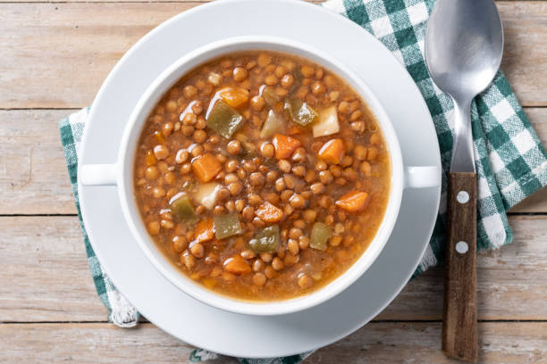 istock Lentil soup with vegetables in bowl on wooden table 2050338653