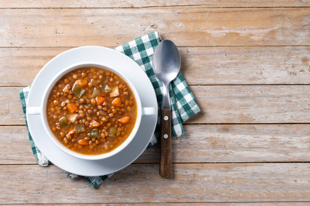istock Lentil soup with vegetables in bowl on wooden table 2050342116