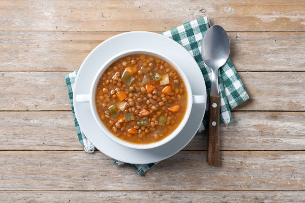 istock Lentil soup with vegetables in bowl on wooden table 2050342348