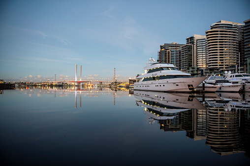 Melbourne, Australia – April 29, 2023: A luxury yacht at Melbourne harbor with city skyline reflection