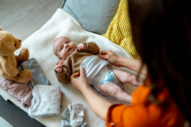 istock Cute baby in bedroom getting diaper changed. 2050356623