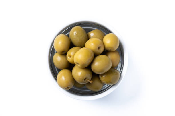 istock Green olives in white bowl isolated on white background. 2050357668
