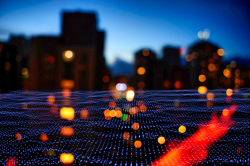 An image capturing the essence of urban connectivity with a focus on a digital grid overlaying a blurred city backdrop at dusk, highlighting the concept of a data-driven infrastructure in an urban setting.