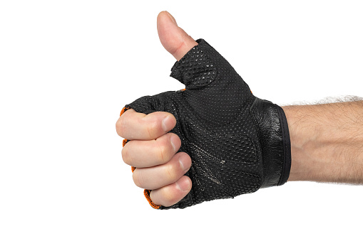 Hand in bicycle gloves shows thumbs up on white background. Workout gloves used to protect the hands from developing corns and calluses.
