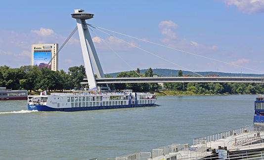 Bratislava, Slovakia - July 10, 2015: Cruiser Ship at Danube River Pass Under Famous UFO Bridge in Capital City.