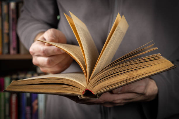 istock Man reading. Book in his hands. Close up 2050432023