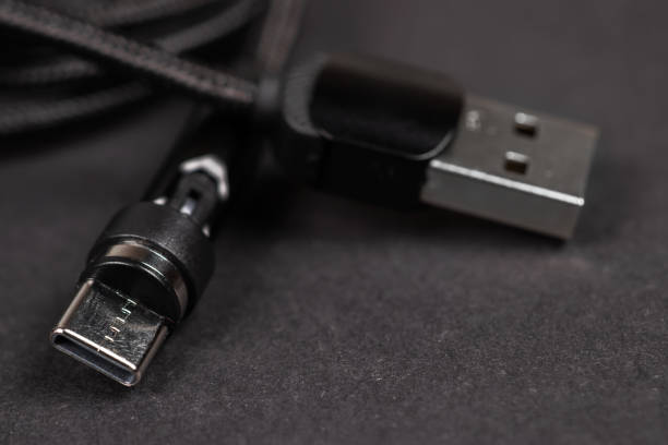 istock Usb cable close up on a black background used to transfer information, hardware connection 2050435277