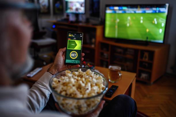 istock Mature men using smart phone for sports betting. 2050459610