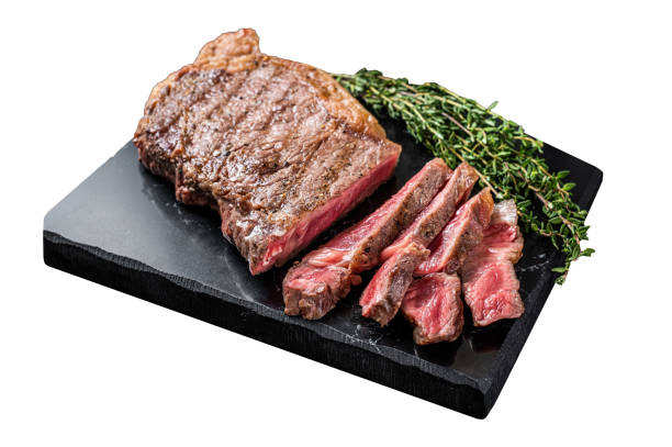 Griiled on BBQ sliced Striploin marbled beef meat steak.  Isolated on white background. Top view.