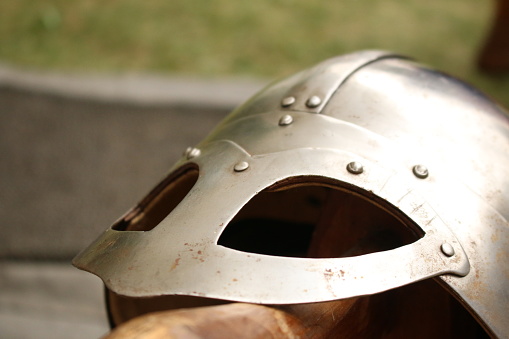 Close-up of a shiny metal silver colored Viking helmet.
