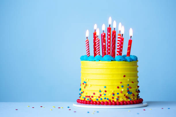 istock Brightly colored celebration birthday cake with red candles 2050475762
