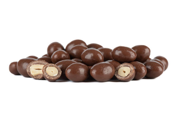 istock A bunch of dark chocolate covered nuts on a white background. 2050487721