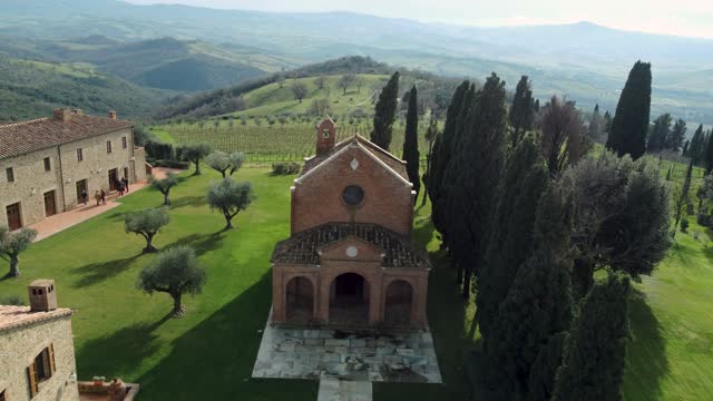 Aerial over Beautiful Italian Tuscany Village with Church and Cypress Trees