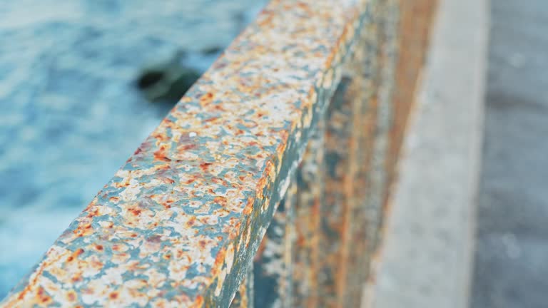 Eroded handrail on Atlantic ocean coastline, close up view