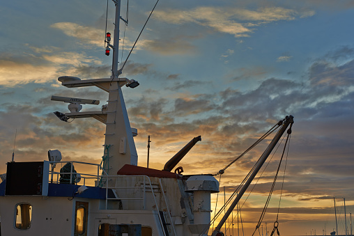 sunset oil tanker at the harbor in the Netherlands transporting gas oil and chemical during sunset