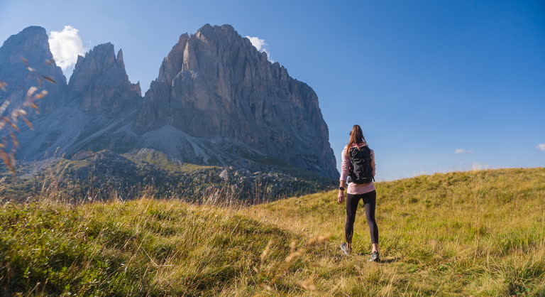 Fit woman hikes through picturesque mountain landscapes