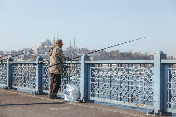 Istanbul, Turkey-February,22: People with fishing lines on Galata Bridge