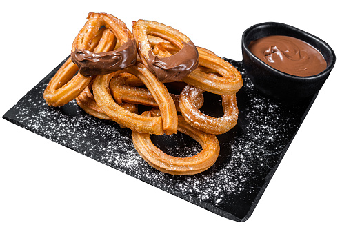 Traditional mexican dessert churros with chocolate sause.  Isolated on white background. Top view