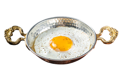 Breakfast with fried egg in a skilet with tomatoes and bacon.  Isolated on white background. Top view
