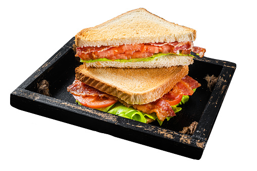 Homemade toasted BLT sandwich with bacon, tomato and lettuce in wooden tray.  Isolated on white background. Top view