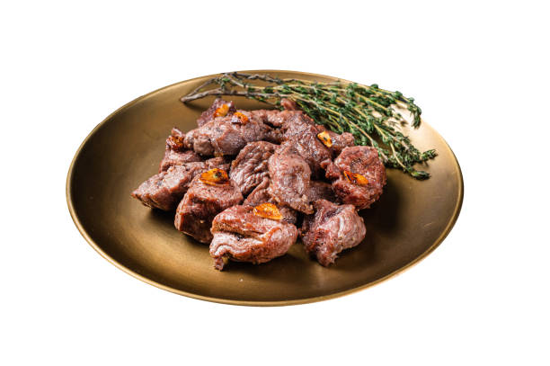 istock Chopped Grilled Diced Beef garlic steak on a plate with thyme.  Isolated on white background. Top view. 2050508634
