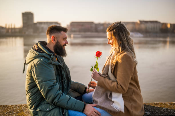 istock Man giving rose to his woman 2050514112