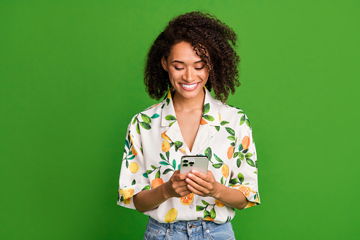 Photo of adorable pretty lady wear print shirt chatting apple samsung iphone modern device empty space isolated green color background