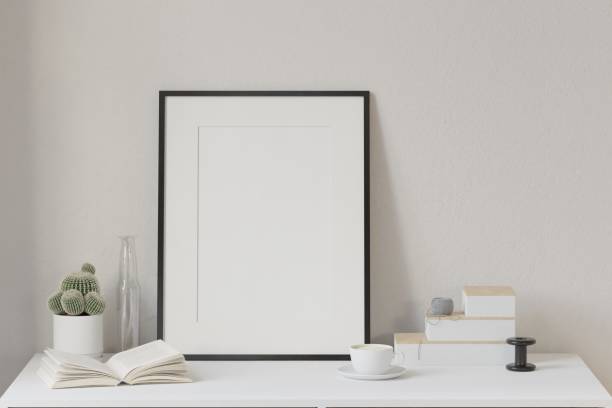 istock Mockup frame, on the work desk in a luxurious morning space with a coffee cup, a book, a cactus vase, home office concept. Scandinavian interior design interior room background, 3d rendering. 2050566103