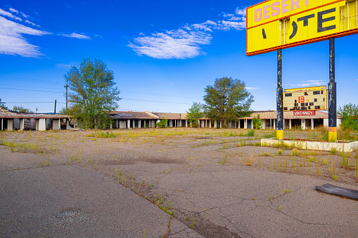 Grants, New Mexico, United States - September 18, 2023: Abandoned Desert Sun motel with old sign board at historic  Route 66, Grants, New Mexico