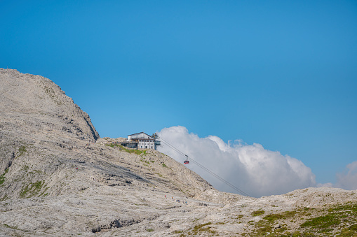 Part of the peak of Pale di San Martino mountains with the mountain refuge and the cable car coming