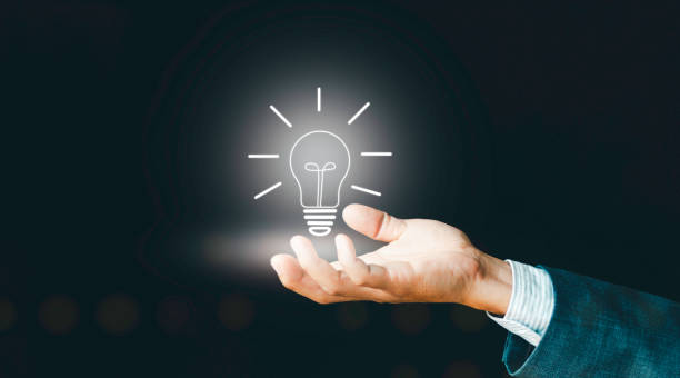 istock Concept creative idea and innovation, Hand of man holding graphic illuminated light bulb, Business process and workflow 2050612138