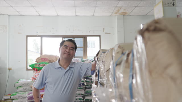 factory concept, Old male businessman, factory owner, looks at camera and smiles