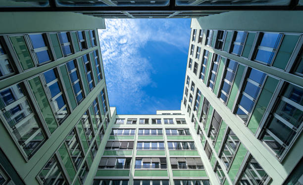 istock Low angle view of modern office building against cloudy sky 2050626665