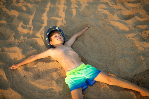 Cute little boy on the beach on summer holidays