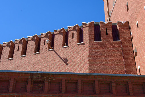Architectural details of the Kremlin's Spasskaya Tower against the blue sky.