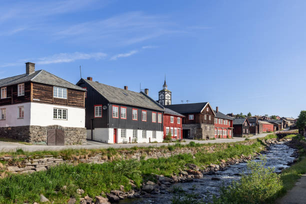 istock Roros presents a harmonious riverside setting where historic wooden architecture and the prominent church clock tower capture the essence of this Norwegian heritage town 2050651416