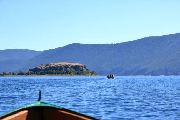 September 13 2023 - Lake Prespa in Albania: Tourists enjoy a boat trip with albanian fishermen