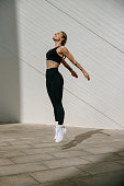 female-athlete-in-sportswear-leaping-in-air-with-wall-backdrop-outdoors-healthy-lifestyle.jpg?b=1&s=170x170&k=20&c=u40ayeDokNgLj9Z0KFlFMjk4csrMysQdRB3i_Z04Xec=