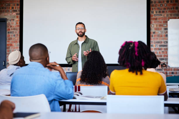 istock Young teacher talking with his students during a class at college 2050661162