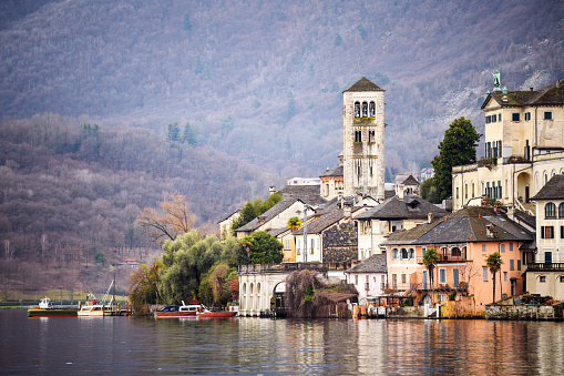 Scenic cityscape of Lugano with Cathedral of Saint Lawrence bell tower and lake view and dramatic light in Lugano Ticino Switzerland