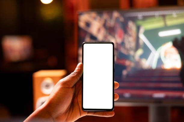 istock Man in home using mockup mobile phone while enjoying FPS game, close up 2050666511