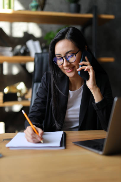 istock An ambitious Asian entrepreneur, with a laptop in an office, communicates effectively, blending professionalism and innovation. 2050670544