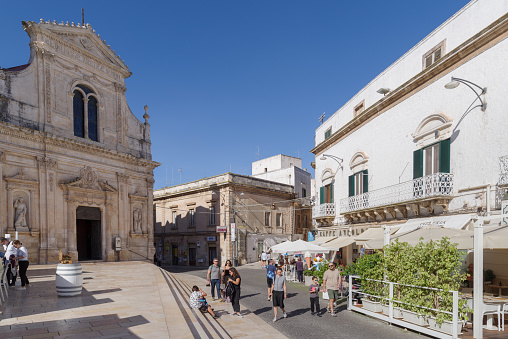 Ostuni, Italy - October 30, 2023: View of whitewashed street in the old town of Ostuni, also La Citta Bianca, The White Town, Itria Valley, Apulia region