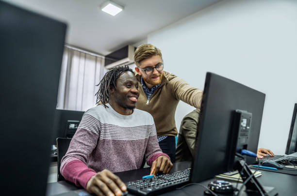 istock Young male teacher helping his students 2050673287