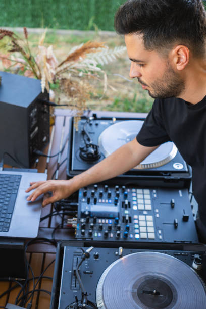 istock Sound engineer preparing the mixing console before the DJ session 2050673824