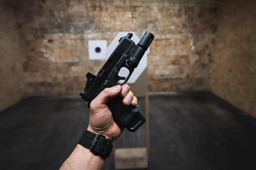 Handgun and bullets on white background, flat lay. Space for text