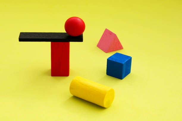 istock Sphere balanced on a trampoline surrounded by other geometric figures 2050694091