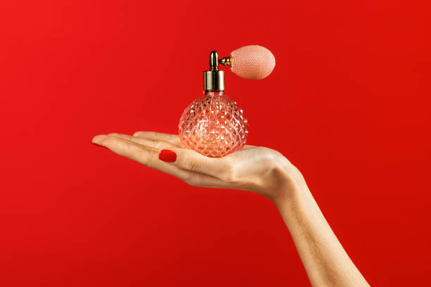 istock Elegant hand holding vintage perfume bottle 2050731218