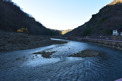 Walporzheim, Germany - 02/13/2023: excavators working in the river Ahr after the flood