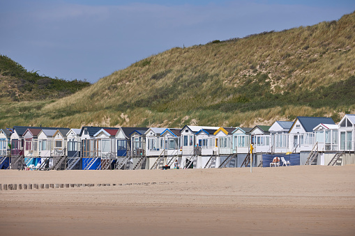 Beach houses on the beach, Domburg, North Sea, Zeeland, Netherlands on a sunny day with dunes in the back.